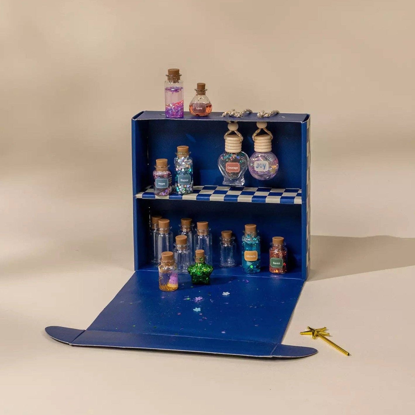 Blue toy shelf with small bottles on a beige background