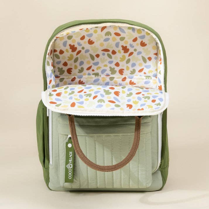 Green backpack with floral interior on a beige background