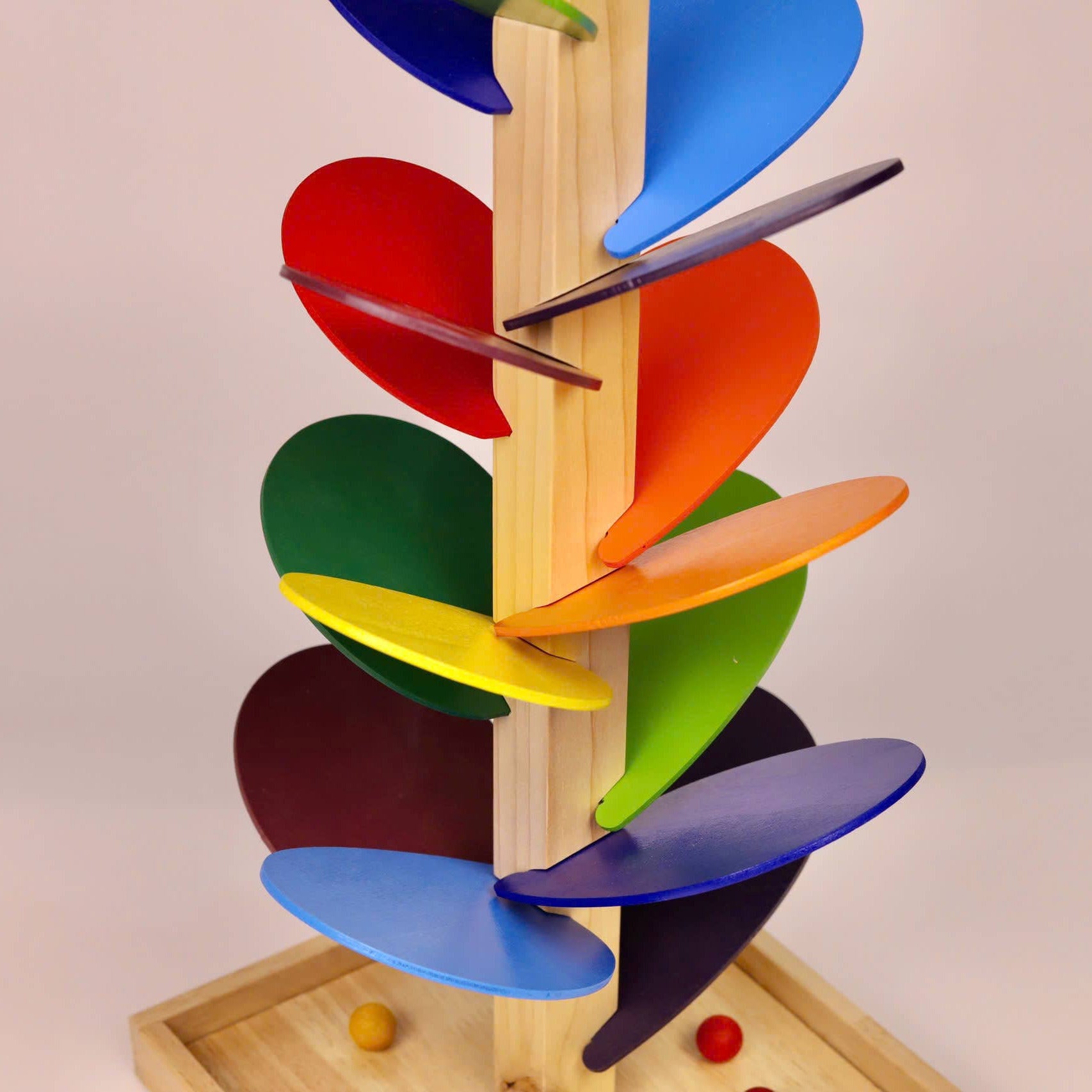 Colorful wooden toy with spinning discs on a beige background