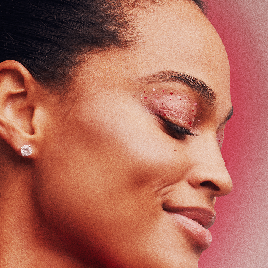 Close-up of a woman's face with a soft pink background