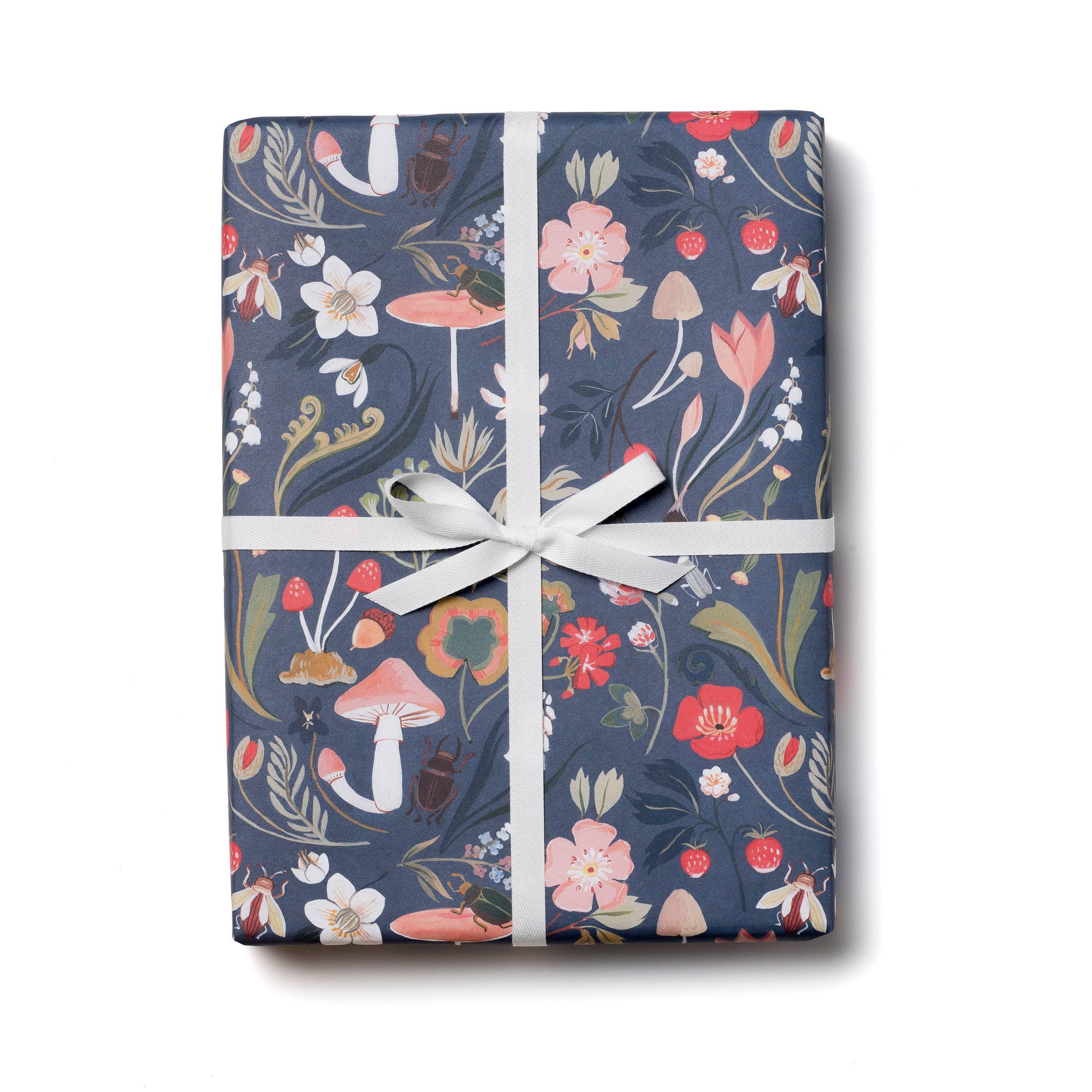 Gift wrapped in floral-patterned paper with a white ribbon on a white background