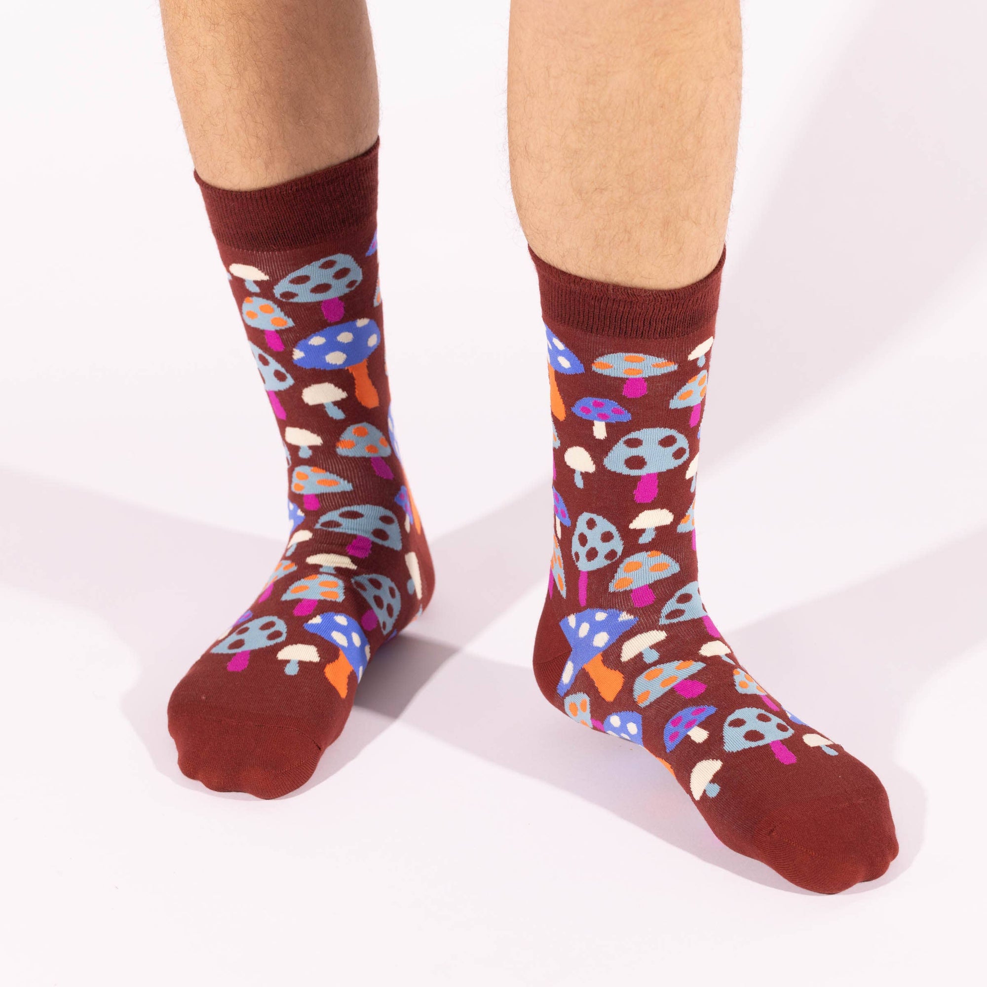 Colorful mushroom-patterned socks on a plain background