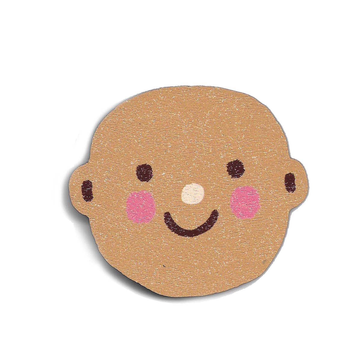 Round wooden cutout of a child's face with a smiling expression on a white background