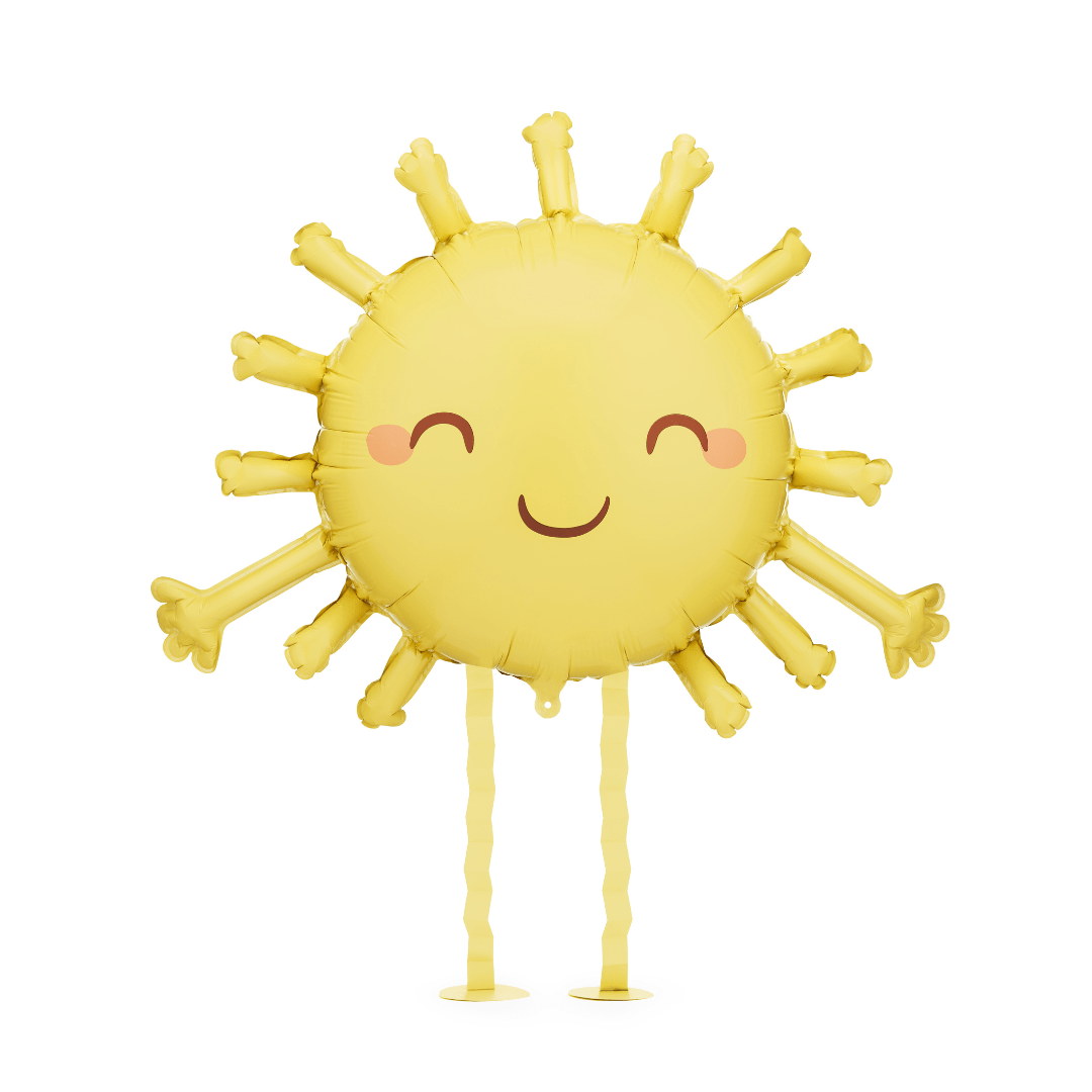 A yellow foil balloon shaped like a smiling sun with wavy arms and legs, pink cheeks, and a dark brown mouth, shown on a plain white background.