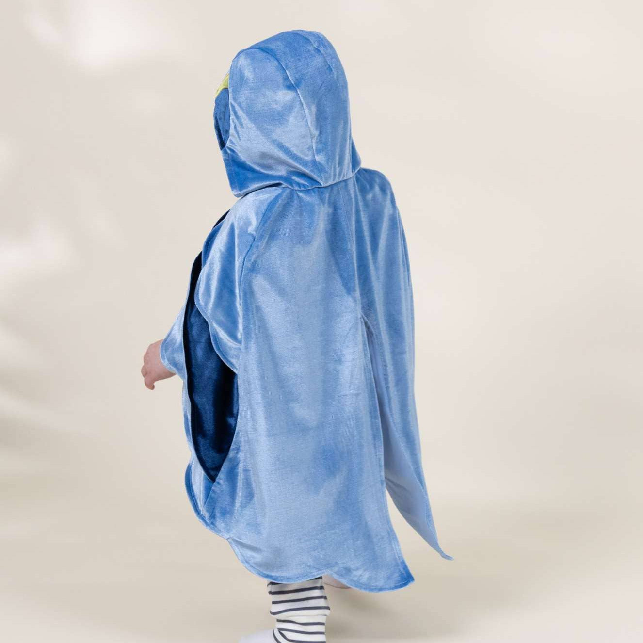 Person wearing a blue poncho on a white background