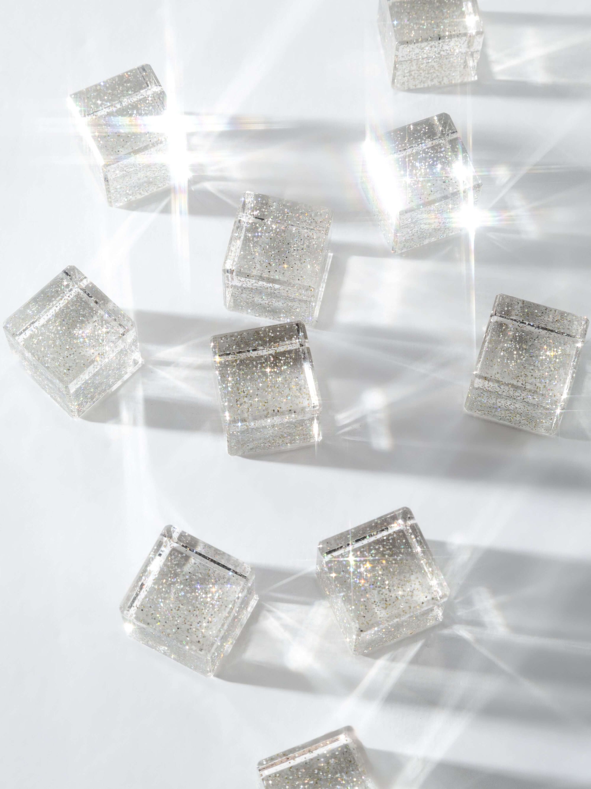 Silver square beads on a white background