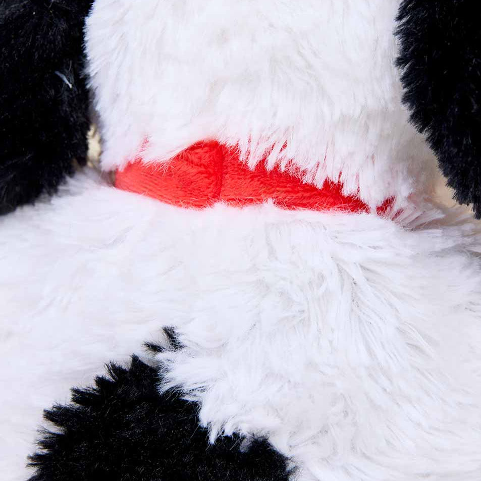 Close-up of a plush dog with black spots and a red nose.