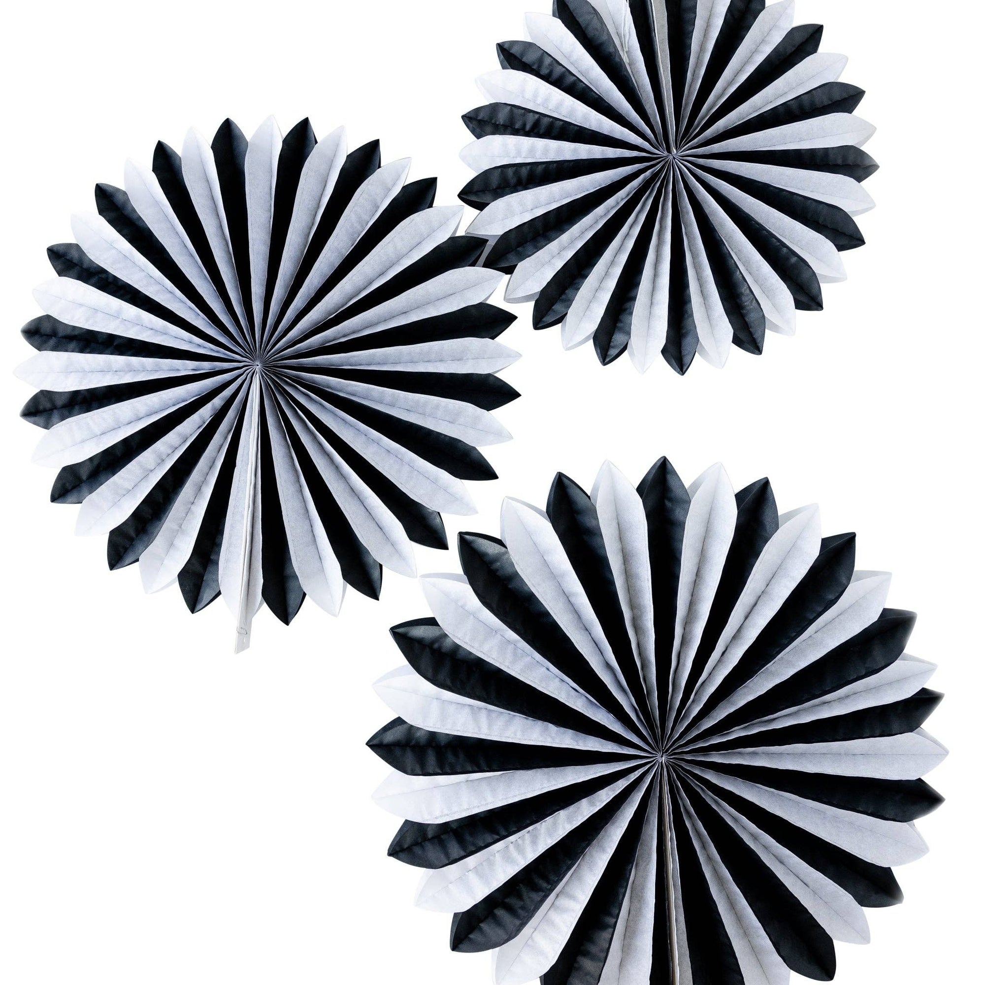 Three black and white paper fan decorations on a white background