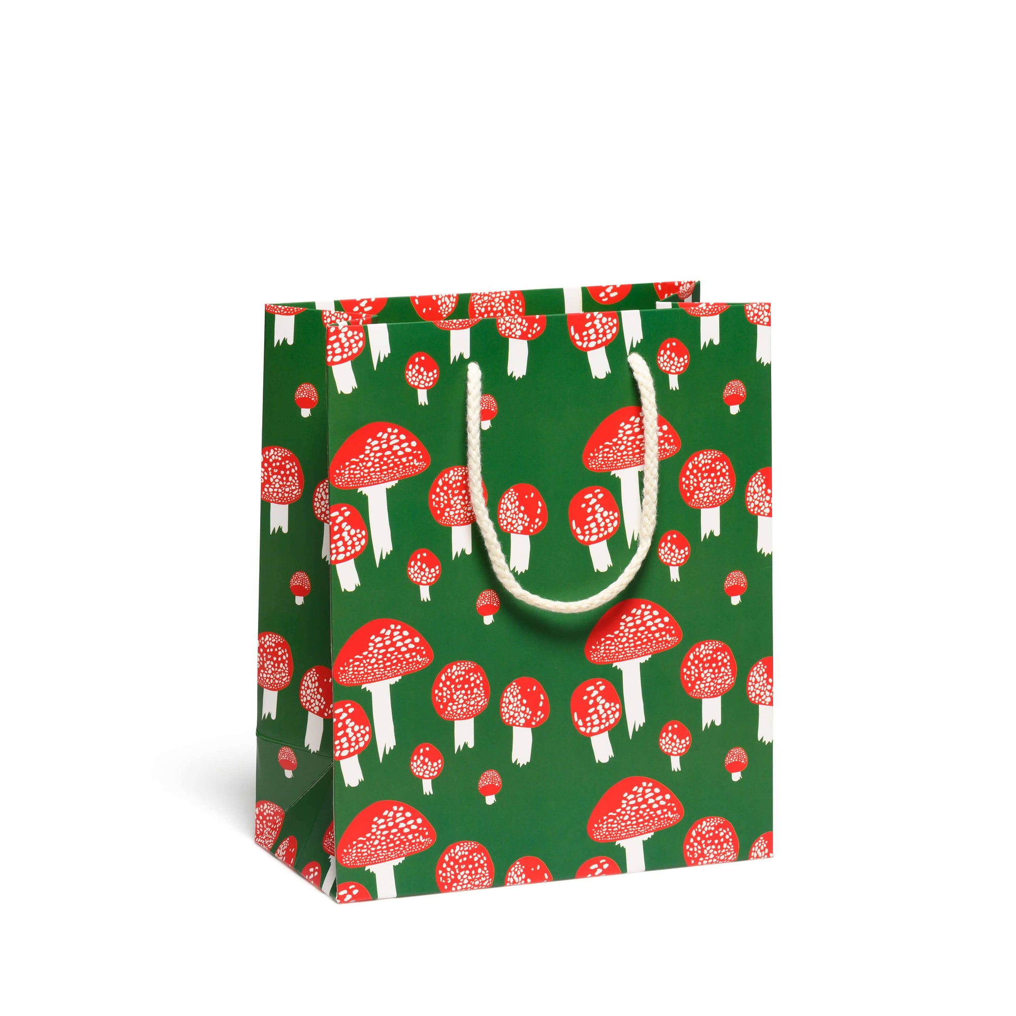 Gift bag with red mushroom pattern on a green background
