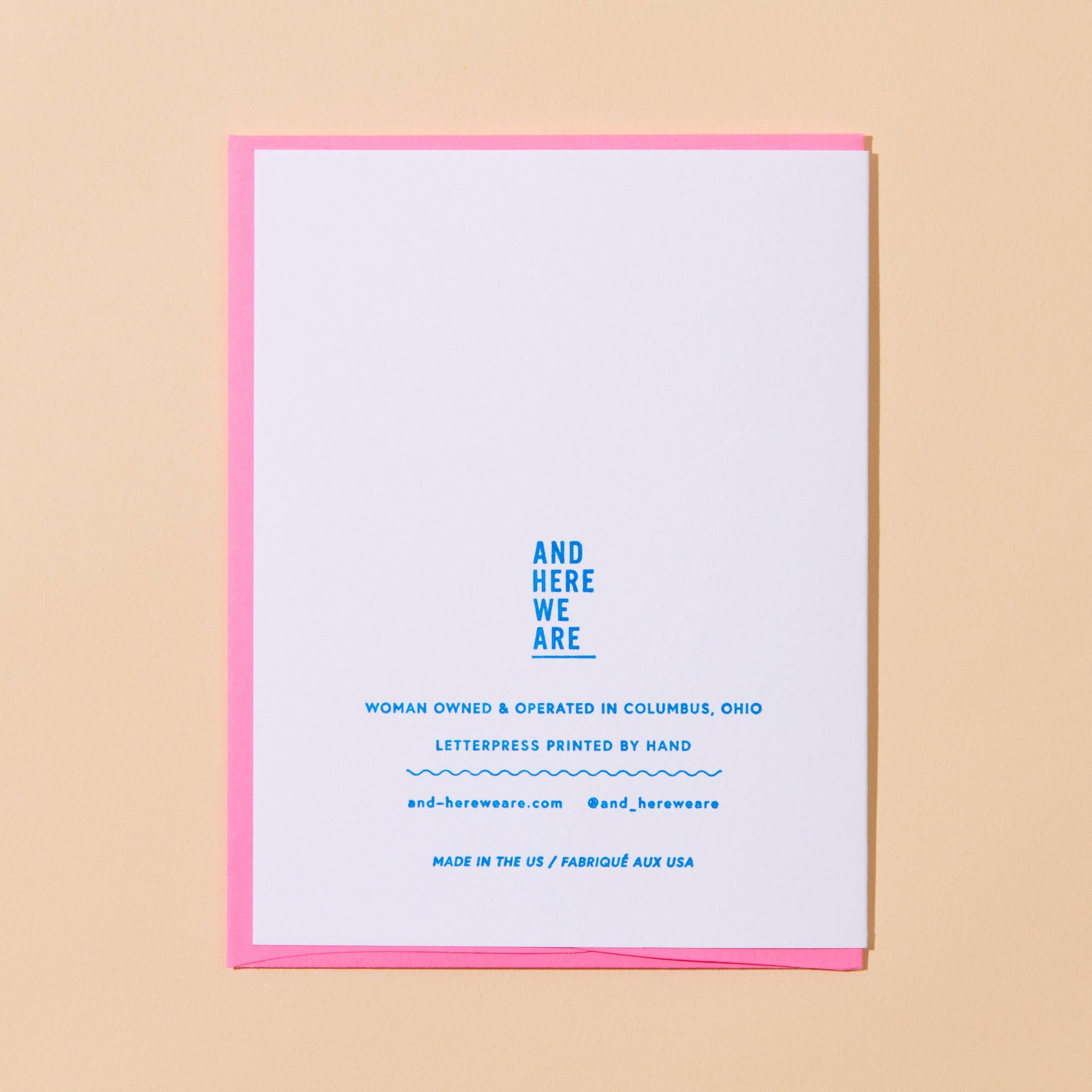 Card with text and pink border on a beige background