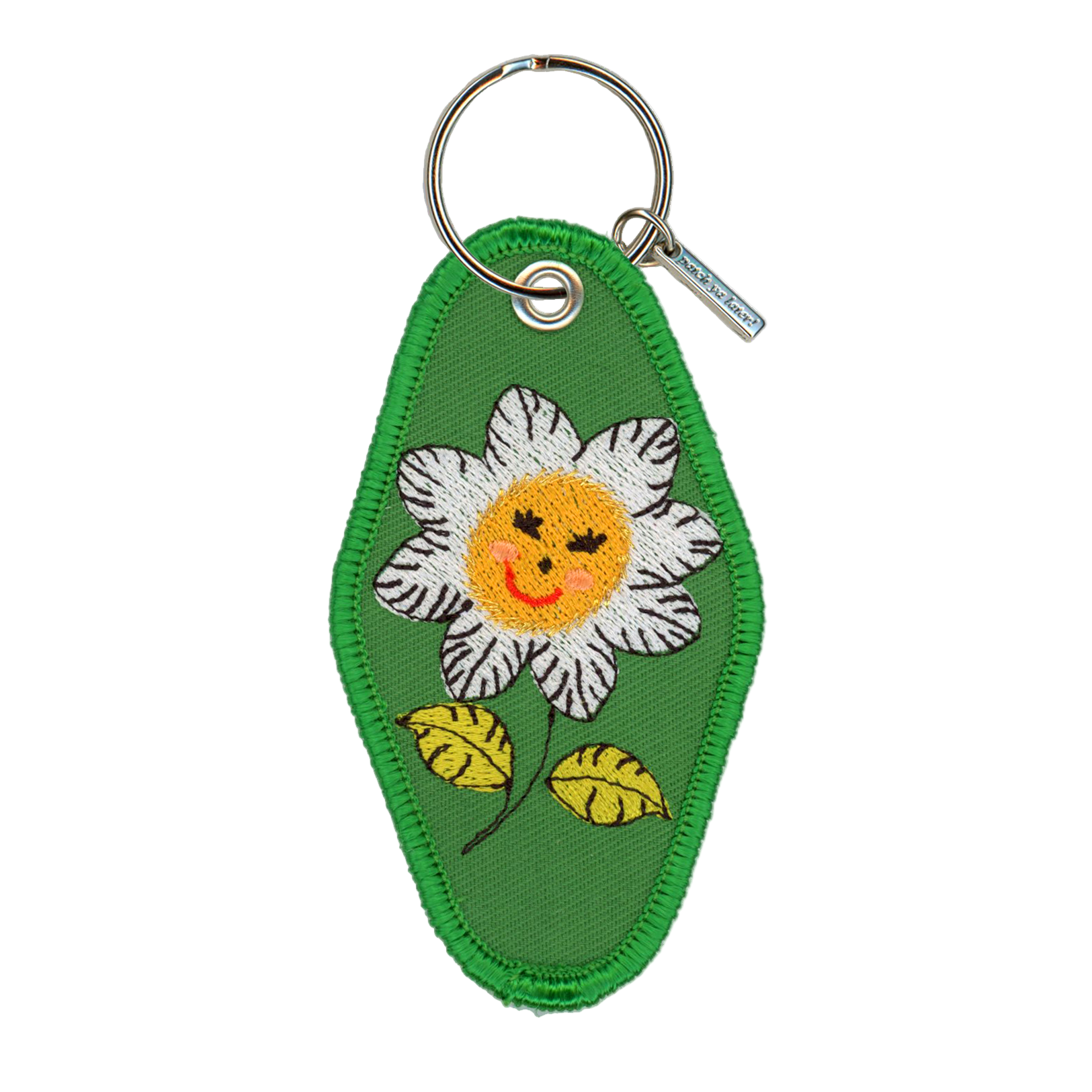 Keychain with a smiling flower design on a green background