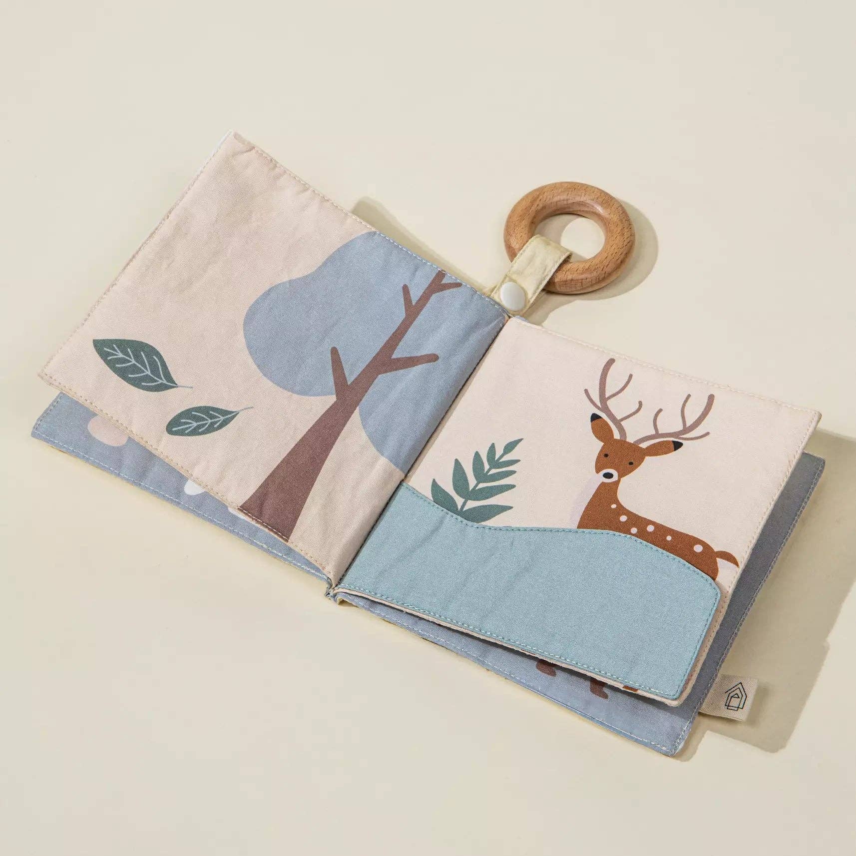 Children's book with a wooden ring on a light beige background