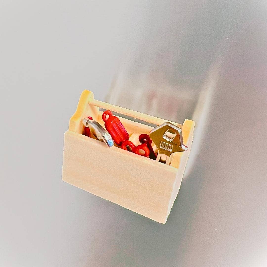 Small wooden box with keys on a light gray background