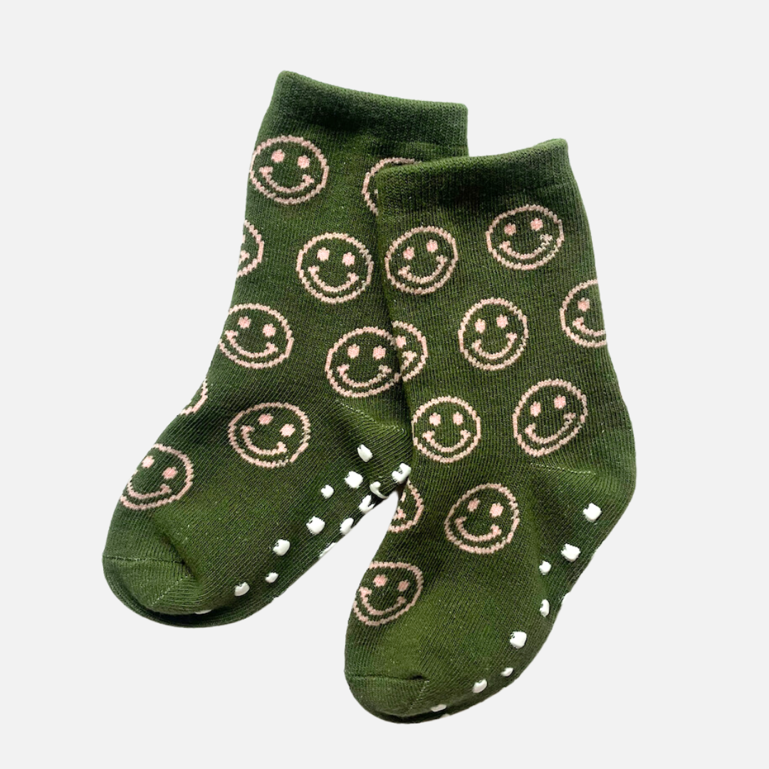 Green socks with smiley face pattern on a white background