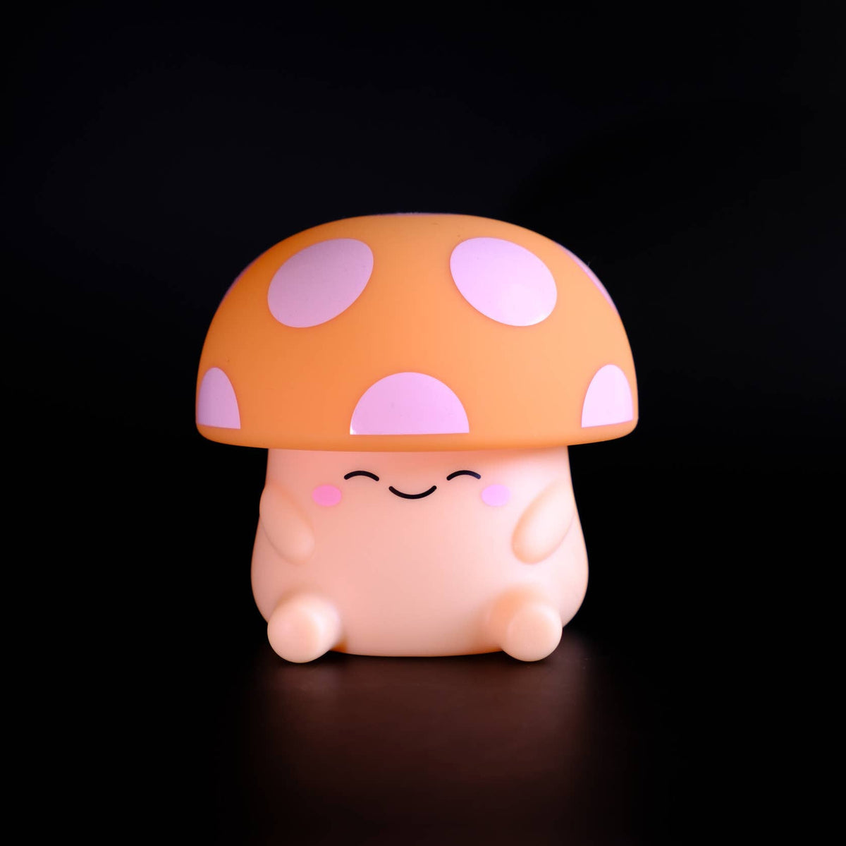 Cute mushroom-shaped figurine with a smiling face on a black background