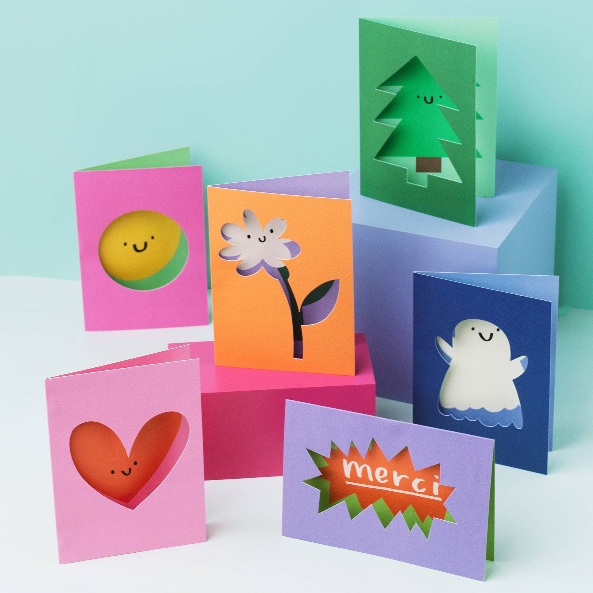 Colorful children's greeting cards with cute designs on a light blue background