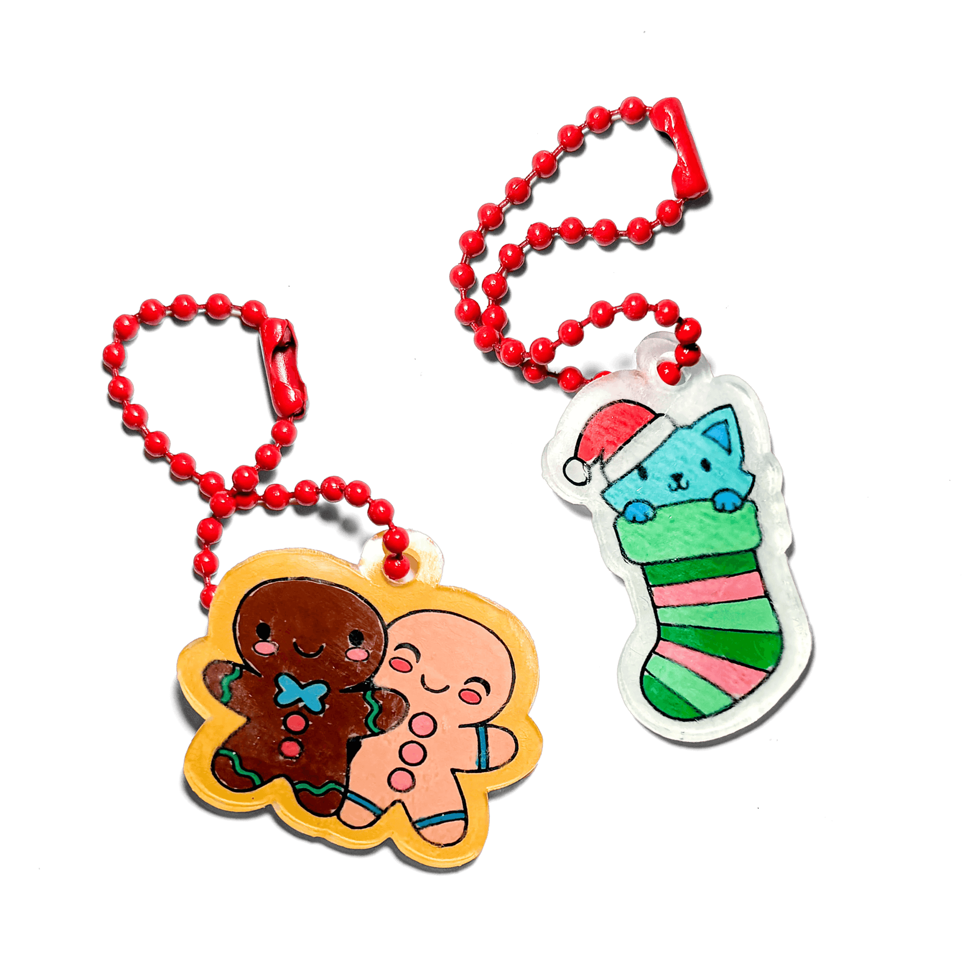 Two Christmas-themed keychains on a green background