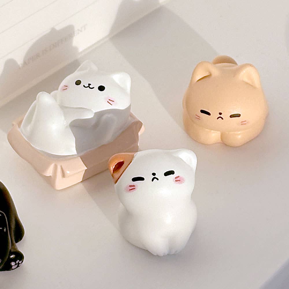 Three cat-shaped night lights on a light background
