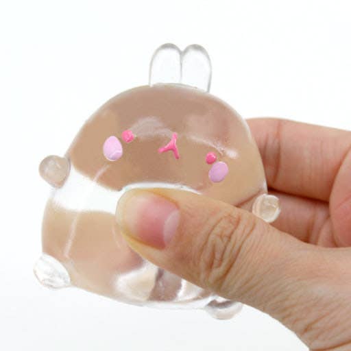 Clear plastic mold shaped like a cartoon character held by a hand on a white background