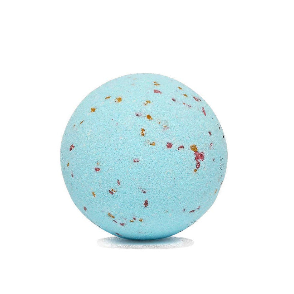 Blue bath bomb with specks on a white background