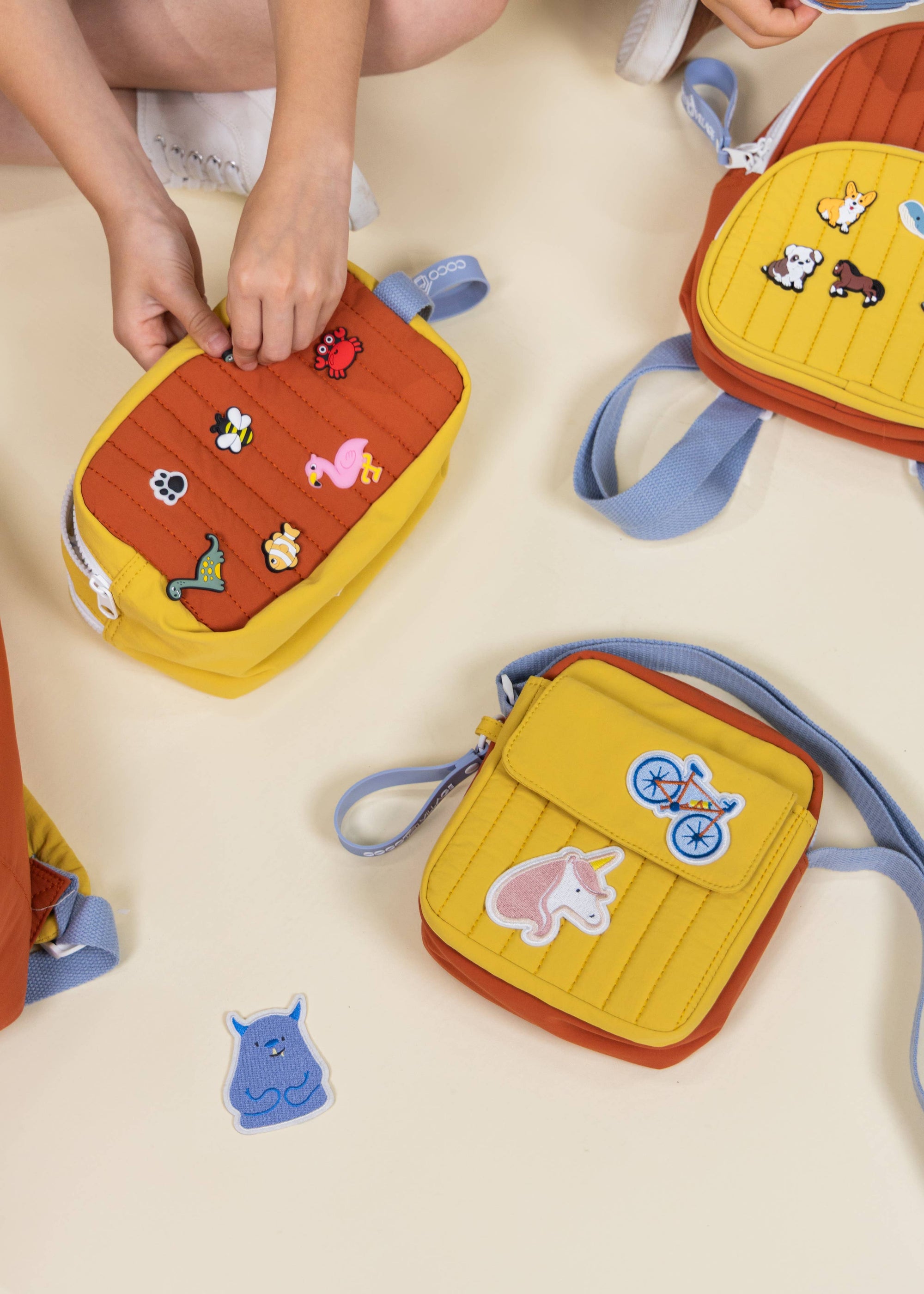 Children's colorful bags with cartoon designs on a light surface