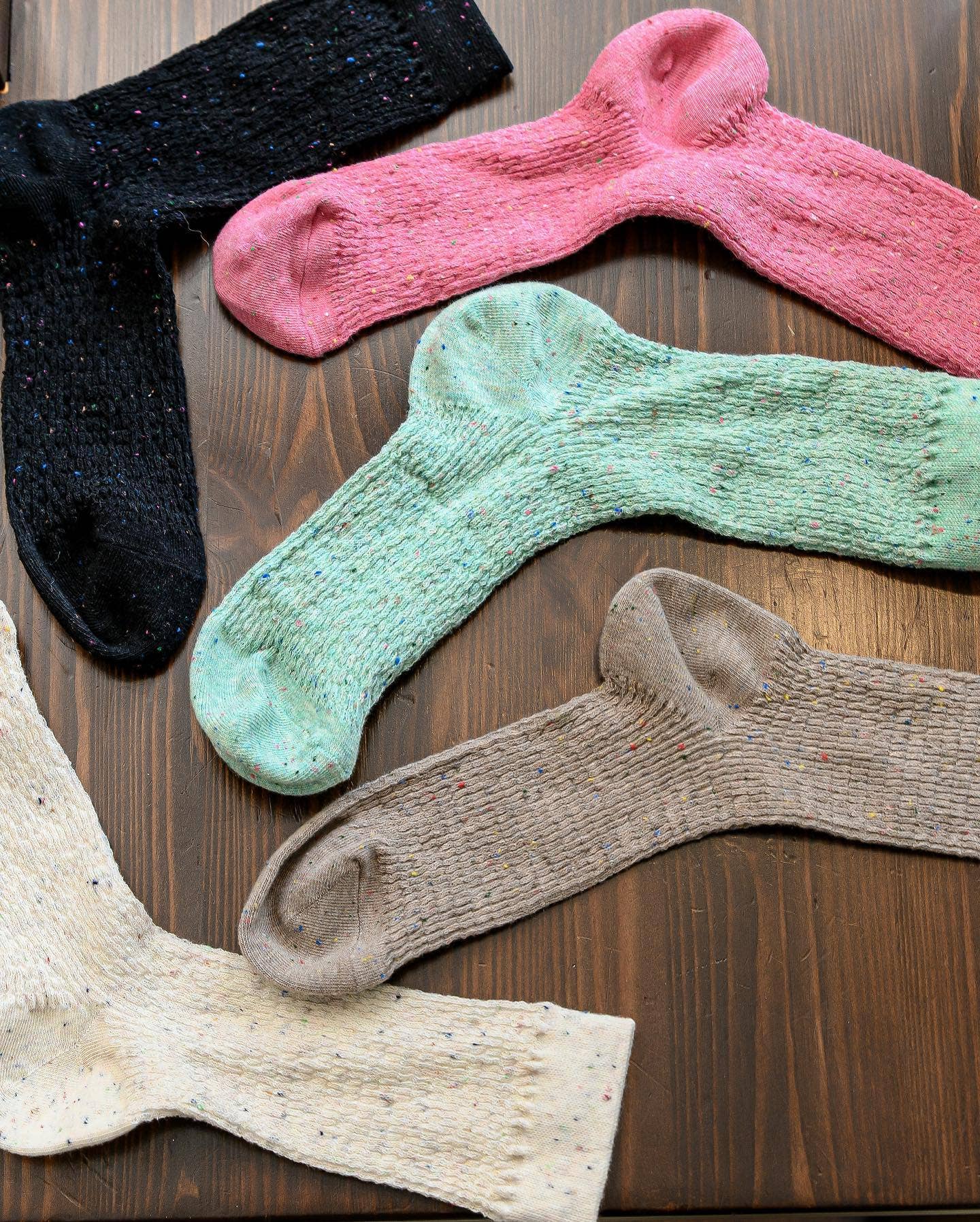Colorful socks arranged on a wooden surface