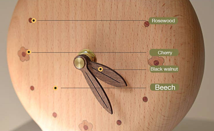 Wooden clock with labeled wood types on a wooden surface