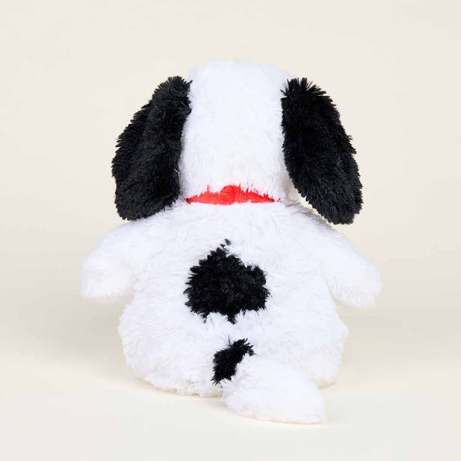 Plush toy dog with black spots and a red collar on a beige background