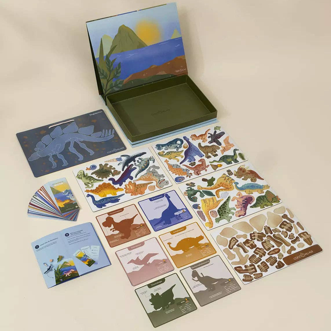 Set of dinosaur-themed cards and stickers on a beige background