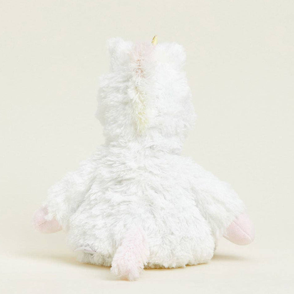 White fluffy toy resembling a cat on a light beige background