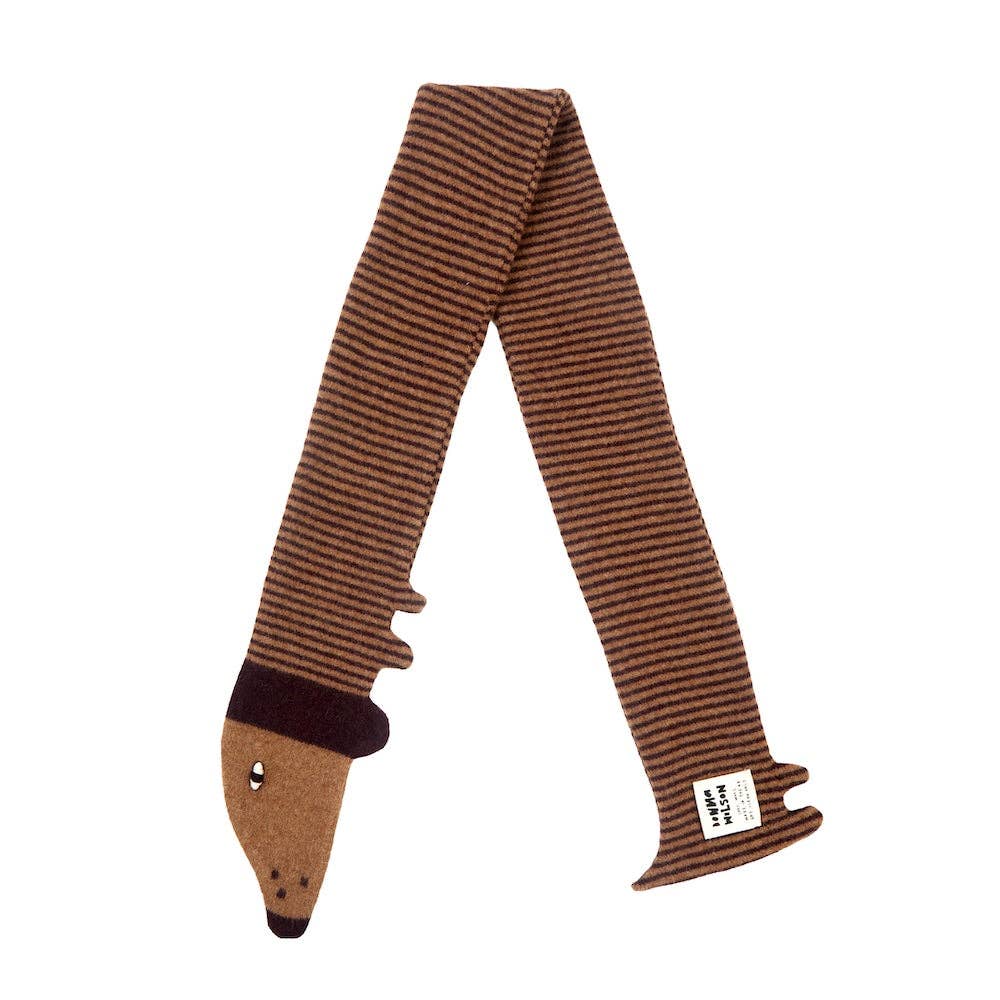 A brown and dark brown striped knit scarf shaped like a fox, featuring a tan face with embroidered eyes and nose on one end and a small white brand tag on the other, shown against a plain white background.