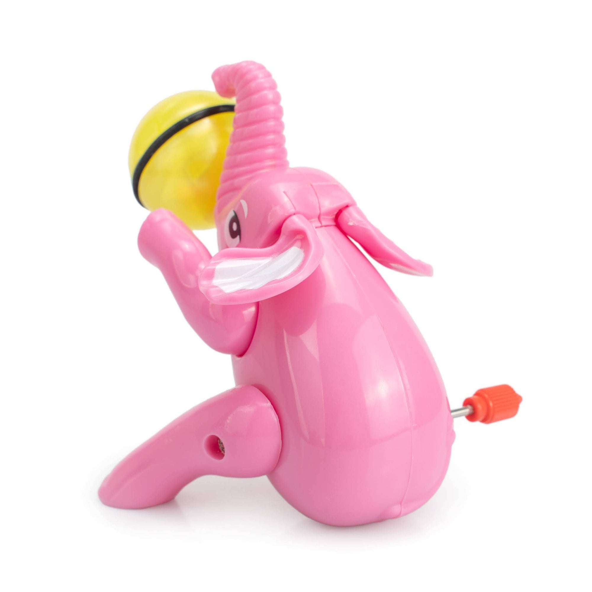Pink elephant toy with a yellow ball on a white background