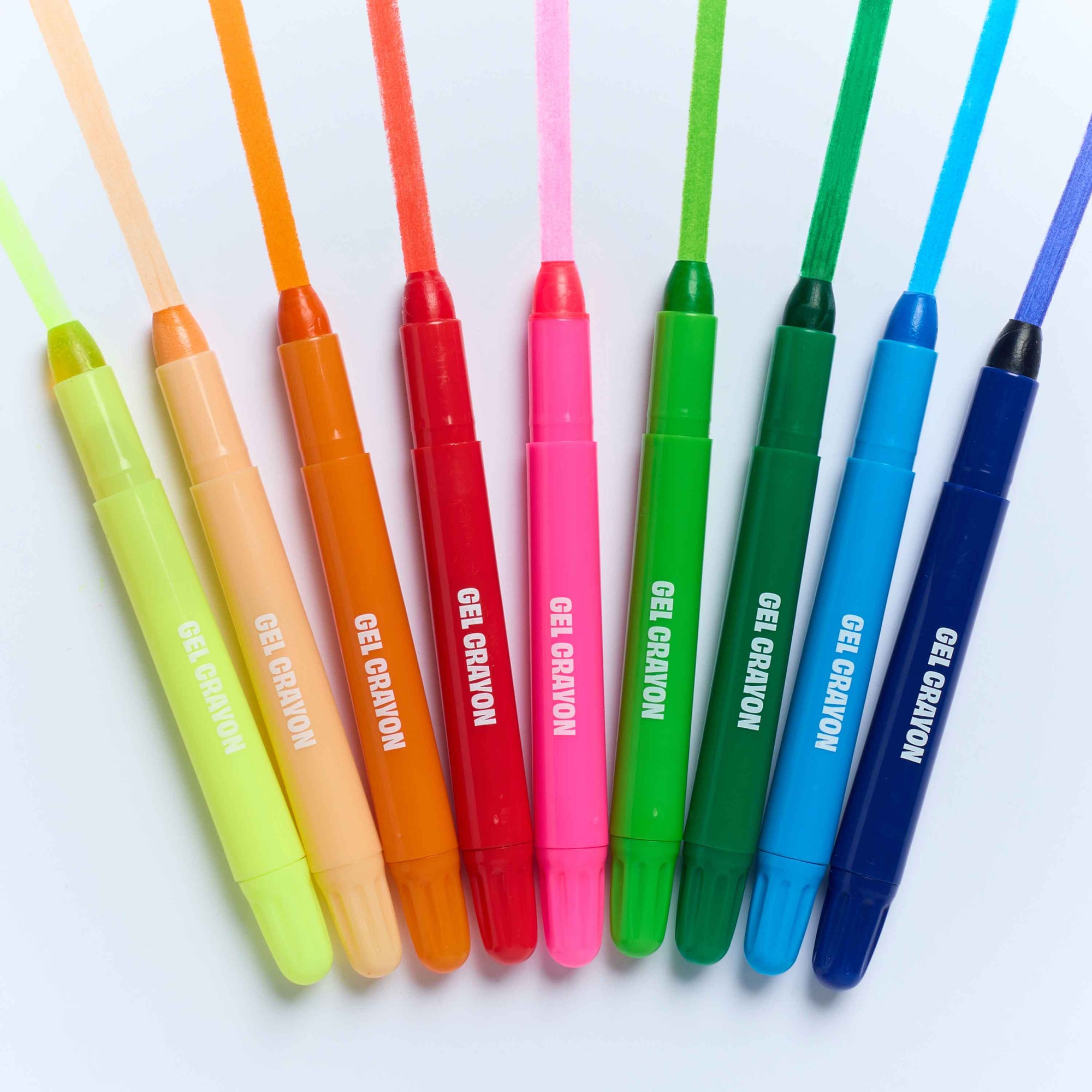 Eight gel crayons in assorted colors arranged in a fan shape on a white background, with 'GEL CRAYON' printed in white on each barrel.