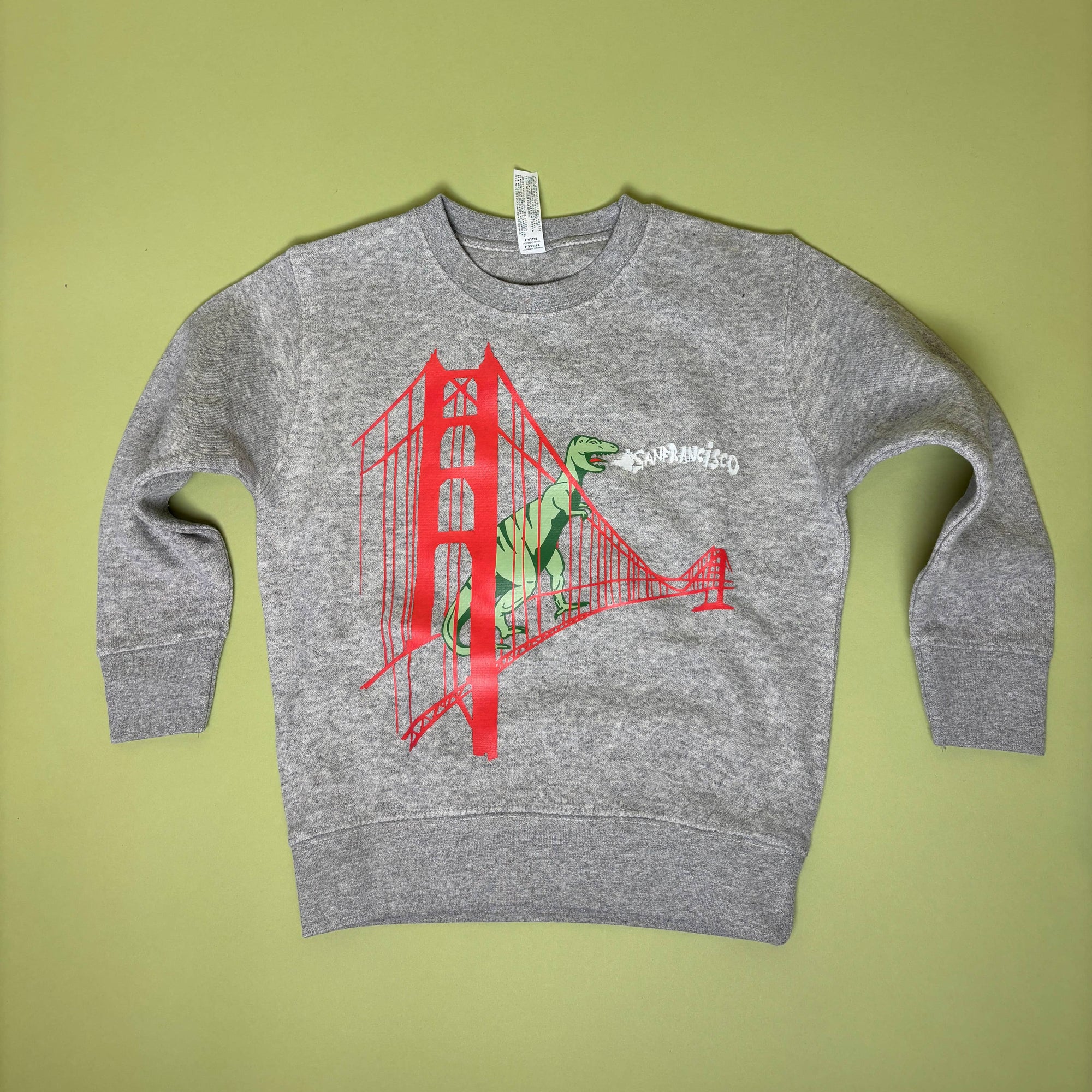 Gray sweatshirt with a red graphic design on a green background