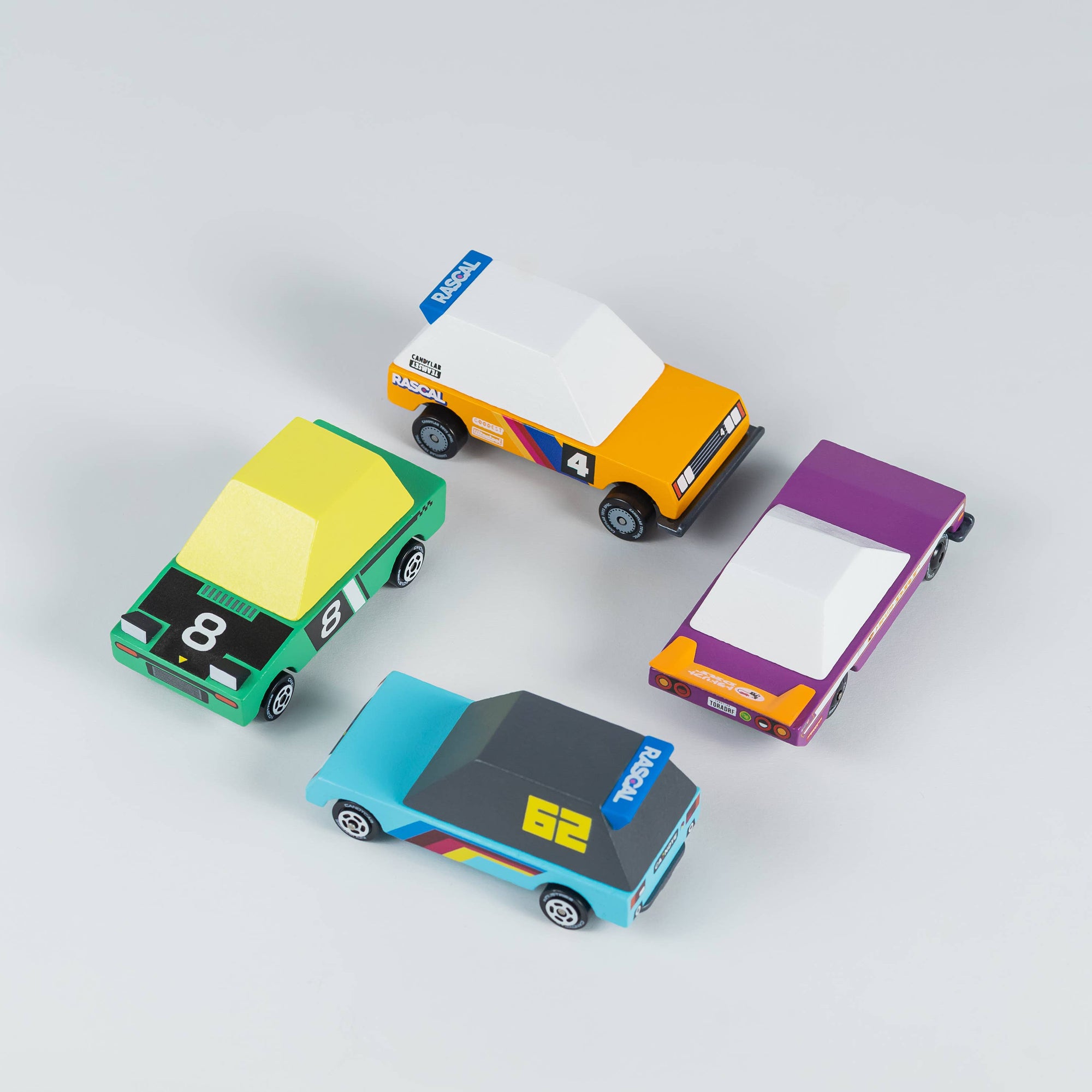 Four colorful toy cars on a light gray background