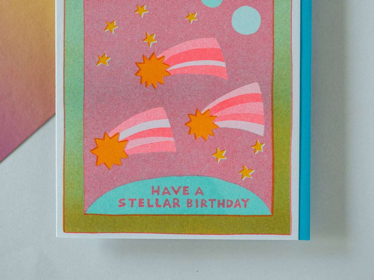 Colorful birthday card with space-themed design and 'Have a Stellar Birthday' text.