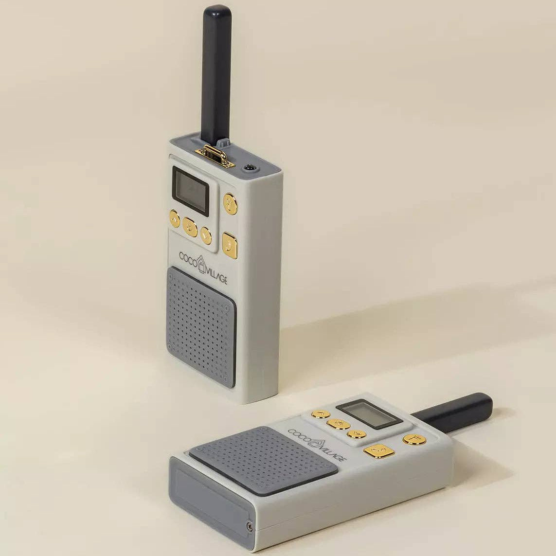 Two gray walkie-talkies on a beige background