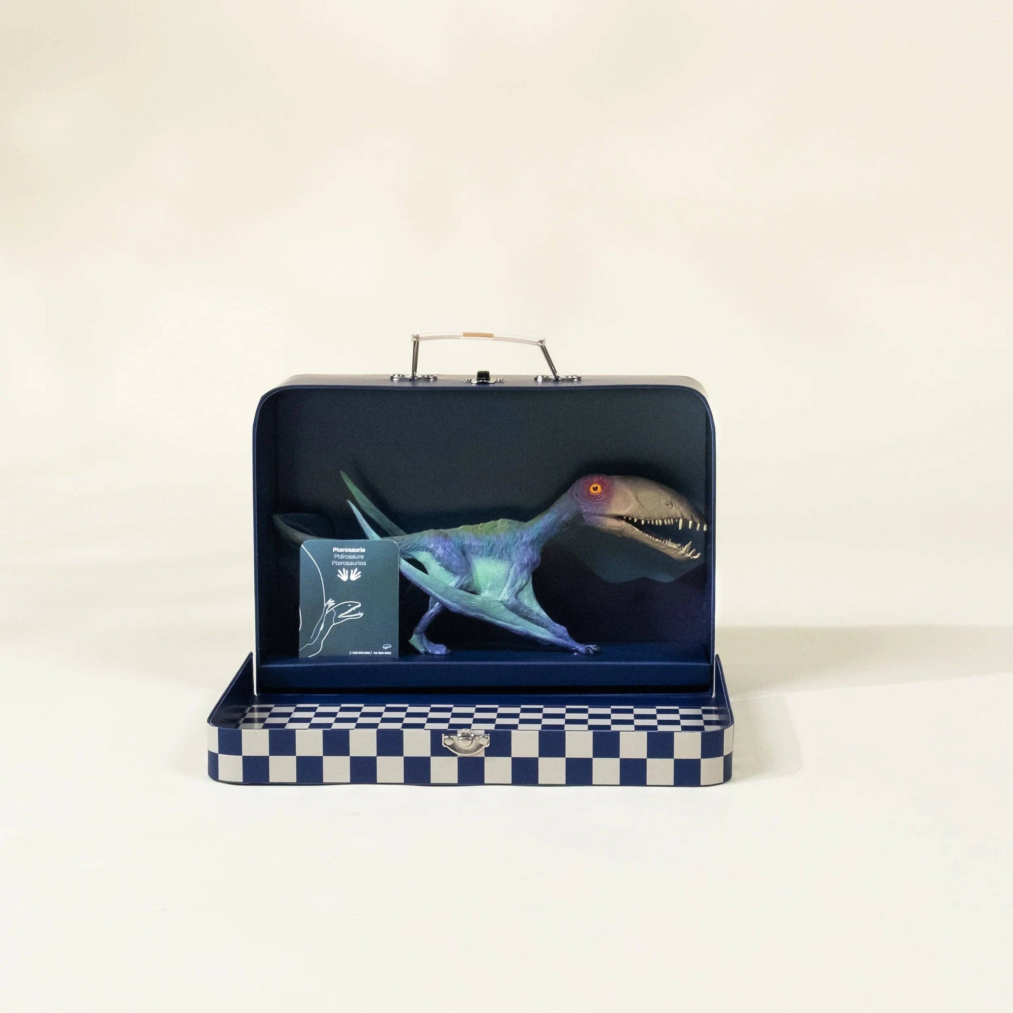Dinosaur toy in a checkered box on a white background