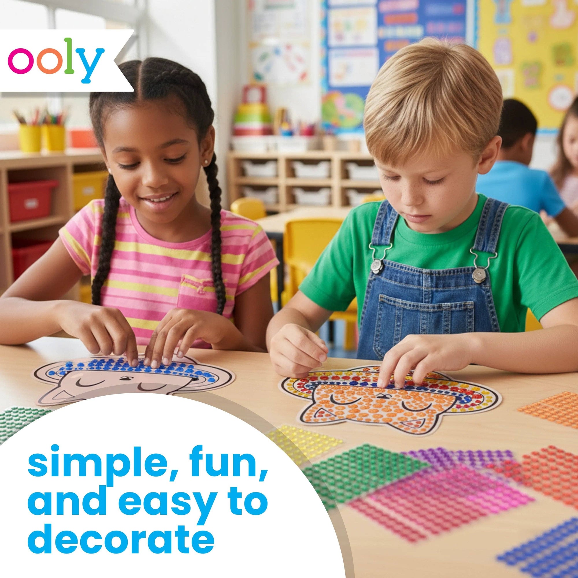 Two children playing with colorful craft materials in a classroom setting, with 'ooly' branding.