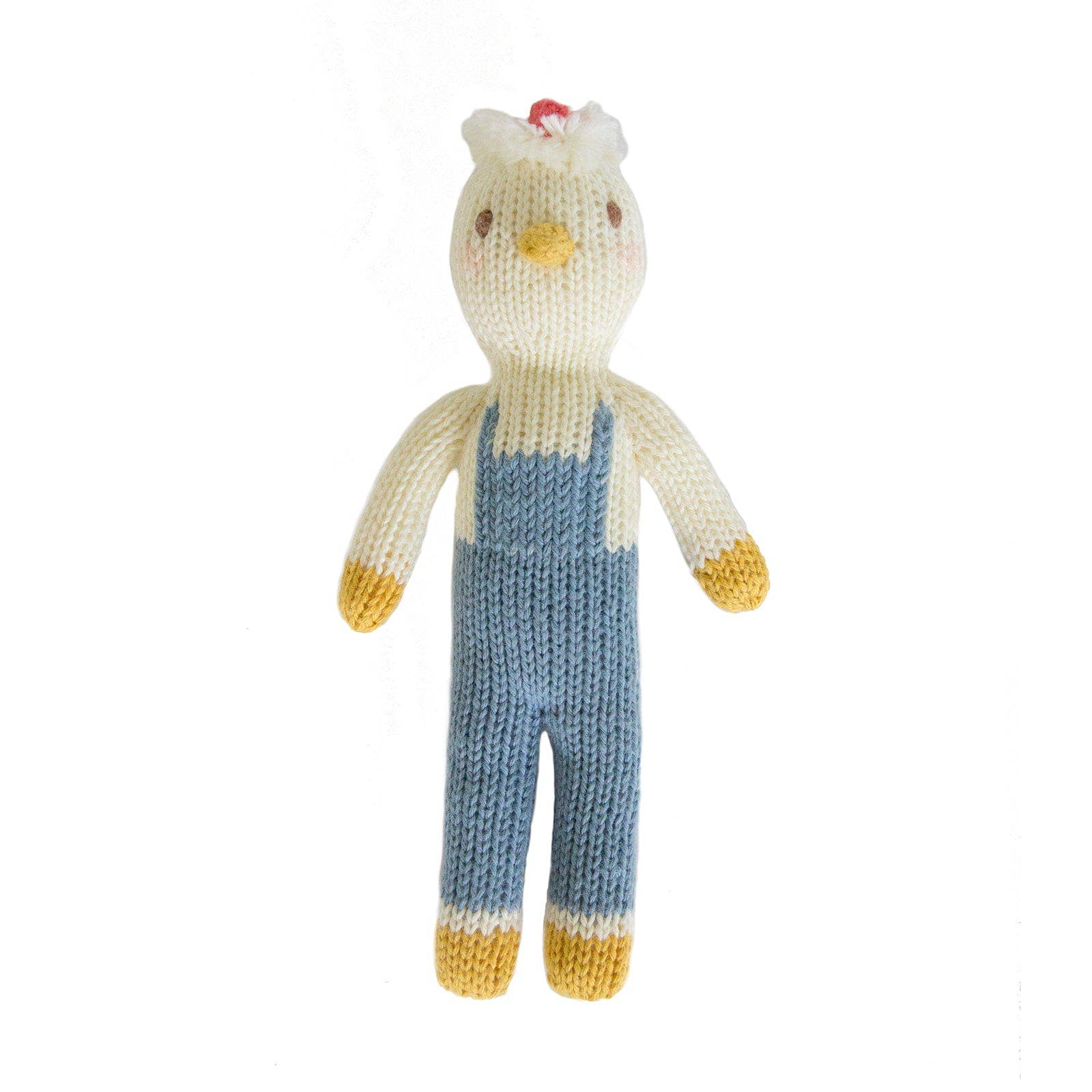 Knitted toy chicken wearing blue overalls on a white background