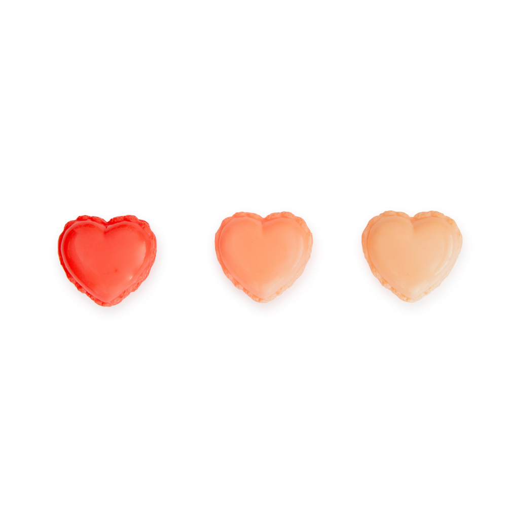 Three heart-shaped objects in red, orange, and pink on a white background