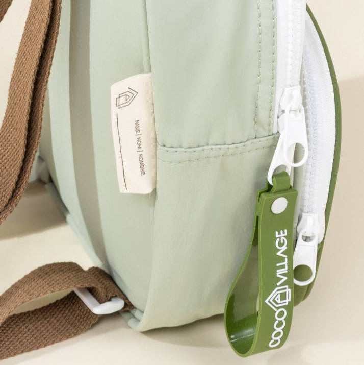 Green bag with a visible brand tag on a light background