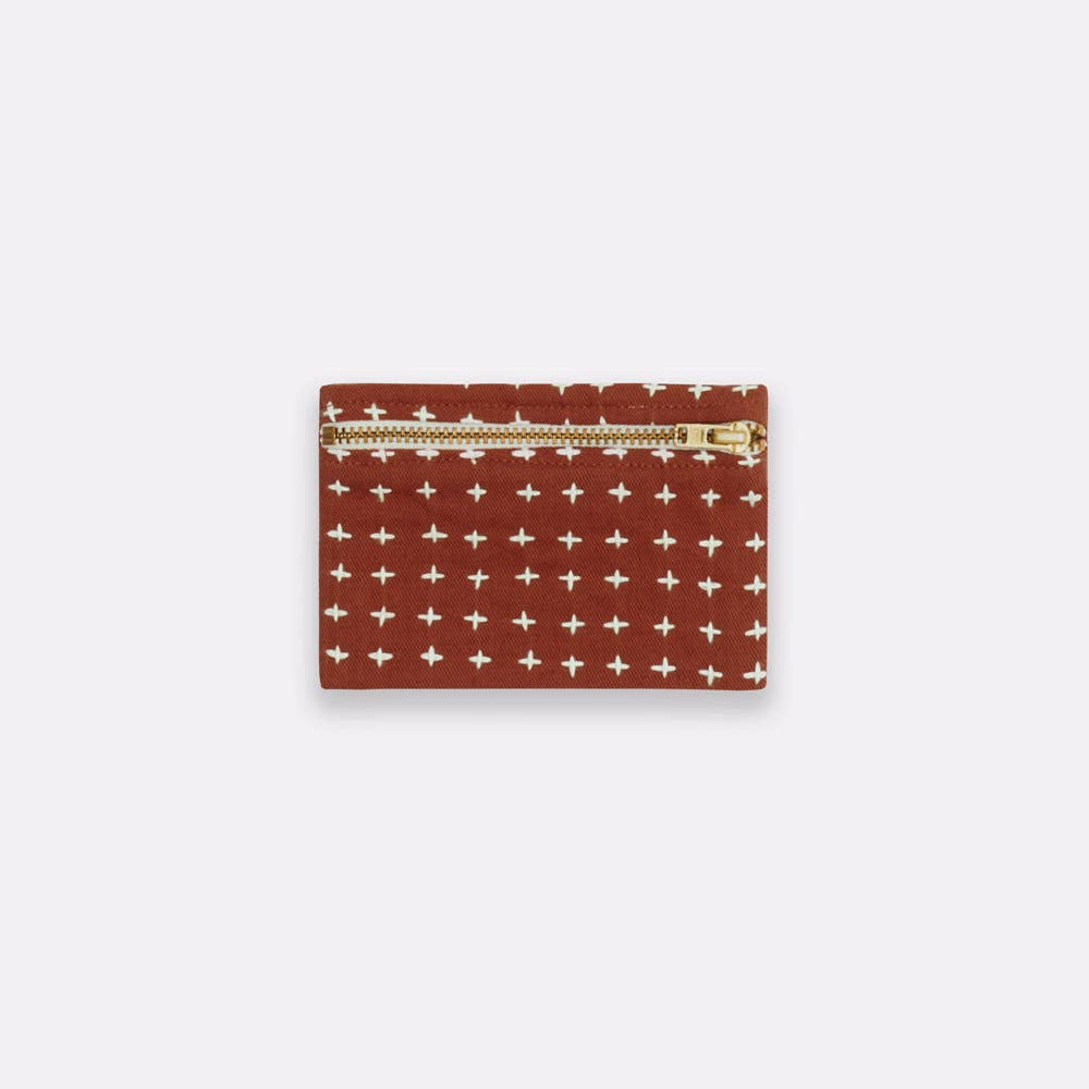 Cardholder with cross pattern and gold zipper on a white background