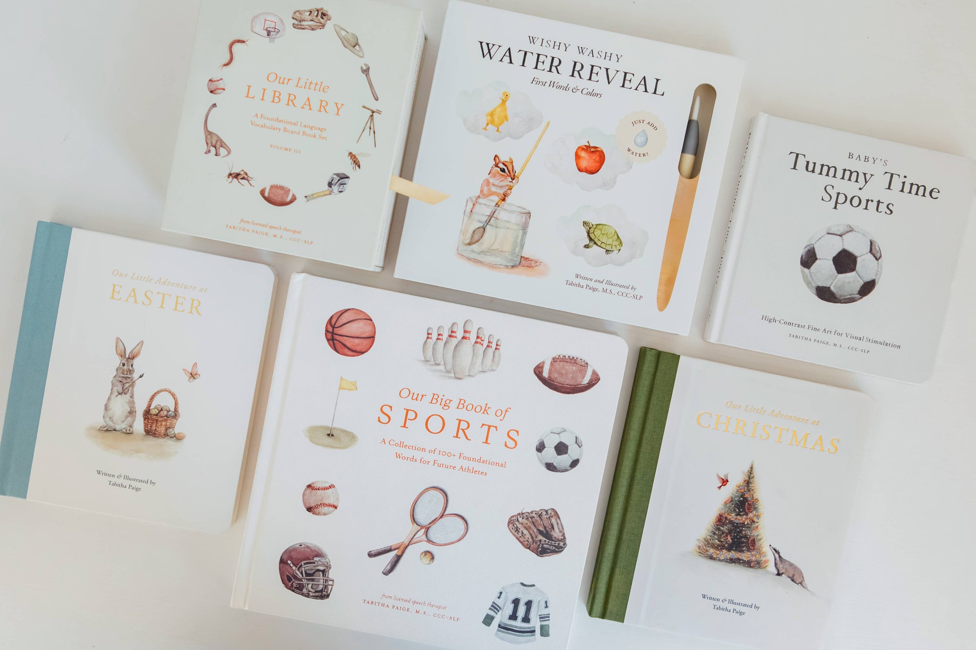 Collection of children's books on a white surface