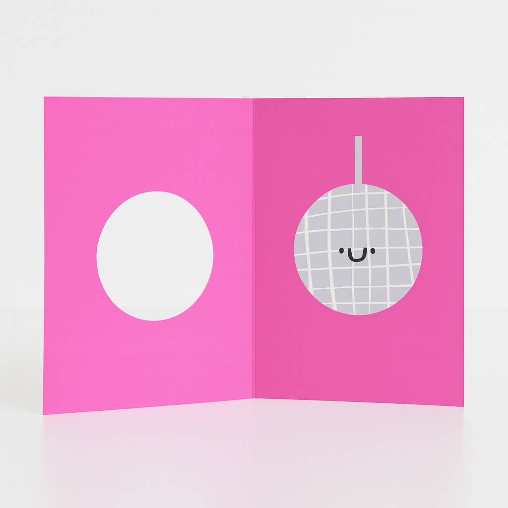 Open pink card with a white circle and a disco ball design on a light gray background
