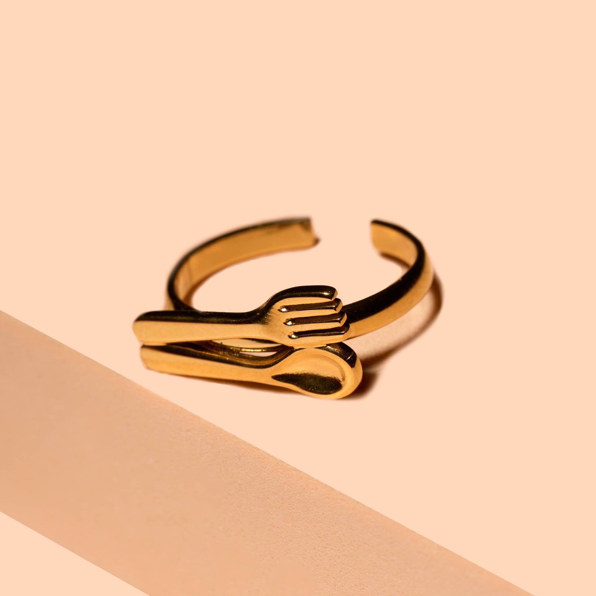 Gold ring on a beige background