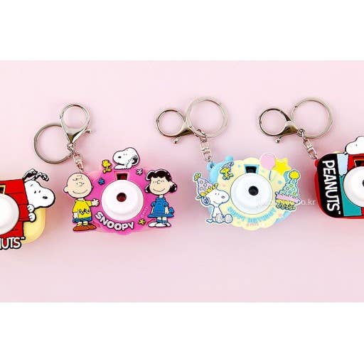 Set of colorful keychains featuring cartoon characters on a pink background