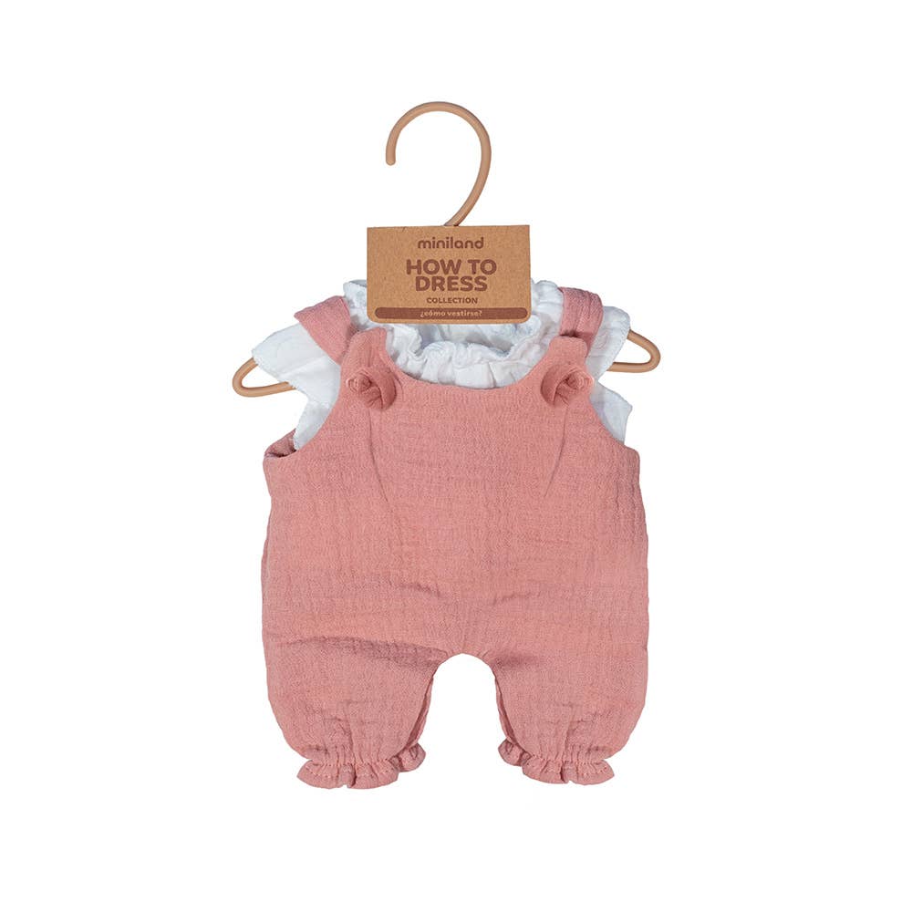 Pink baby romper with ruffled details on a hanger against a white background