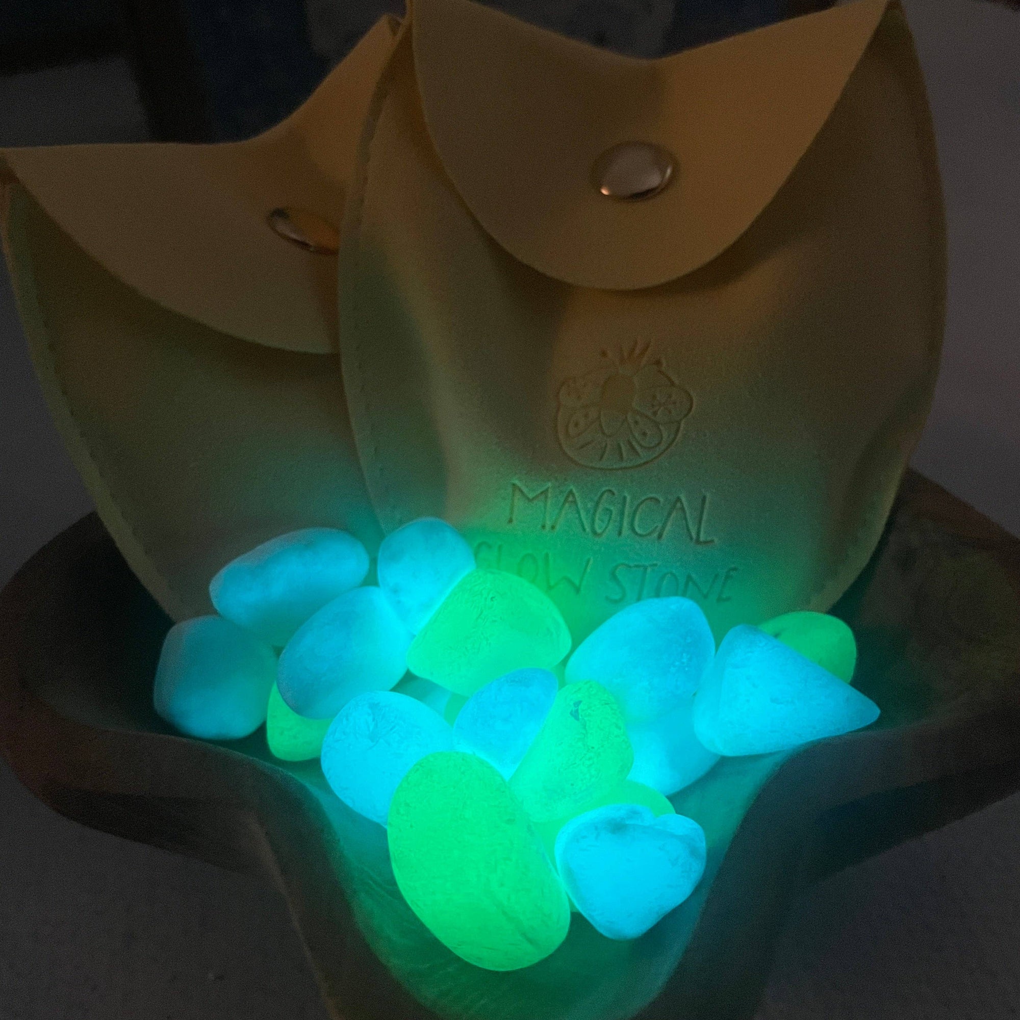 Glowing green stones in a yellow container with 'Magical' branding.