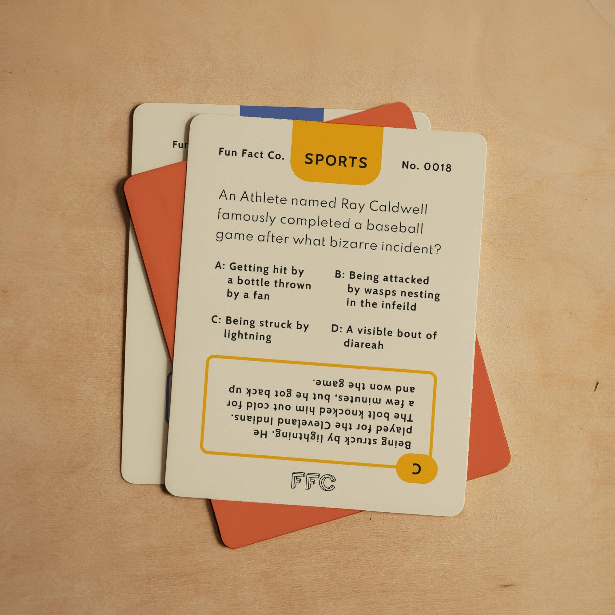 Card with trivia question on sports topic, featuring Fun Fact Co. branding, on a wooden surface.